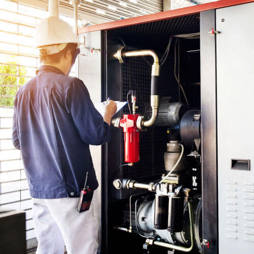 Service technician inspecting commercial unit